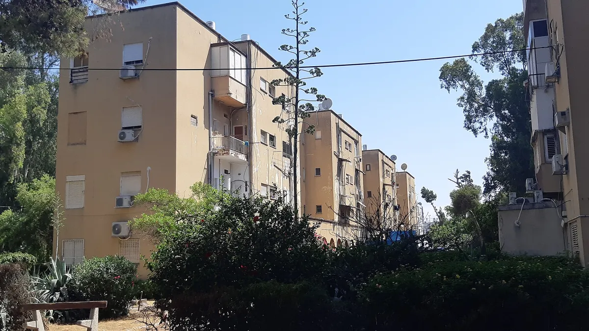 Four-storey apartment blocks among gardens in the Kiryat HaChashmal area of Kiryat Haim